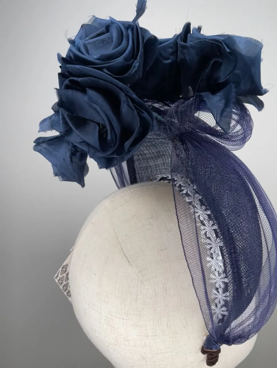 melanie_ferrero__navy_sin_2.webp Melanie Ferrero - Navy Sinamay Halo with Silk Flowers